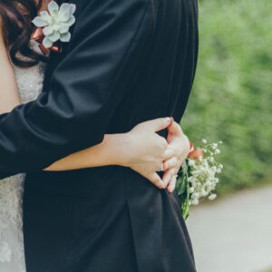 Close-up of a bride and groom hugging in a lush Kowloon garden, capturing wedding romance.